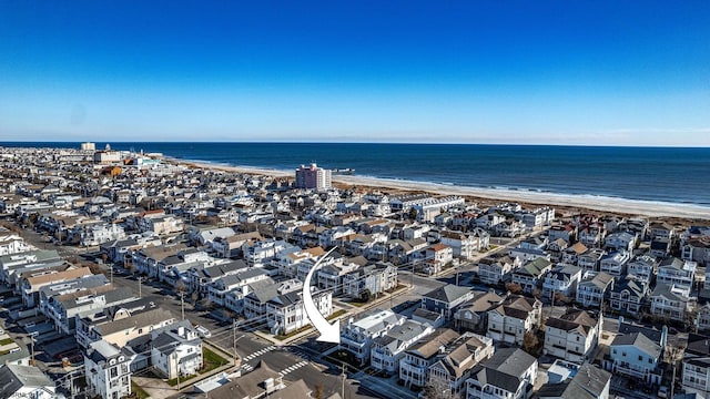 aerial view with a water view and a view of the beach