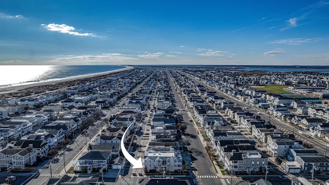 drone / aerial view with a beach view and a water view