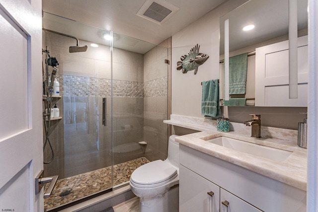 bathroom with vanity, an enclosed shower, and toilet