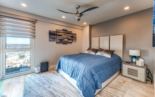 bedroom with light wood-type flooring and ceiling fan