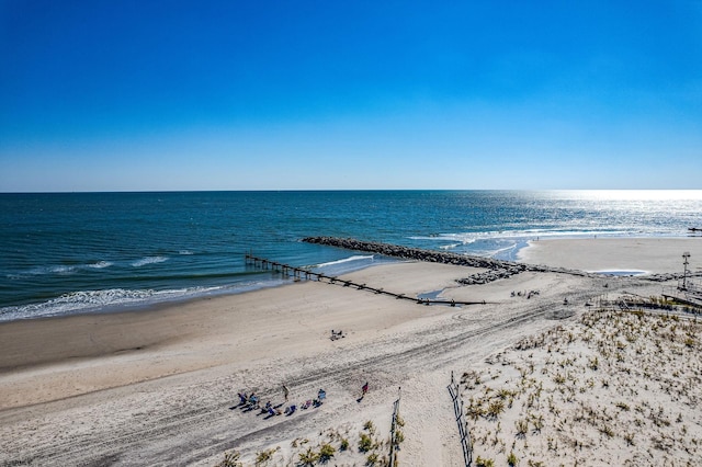 aerial view with a water view and a beach view