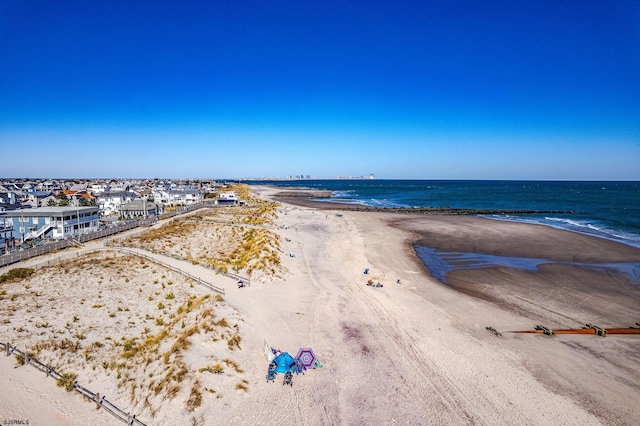 bird's eye view with a water view and a beach view