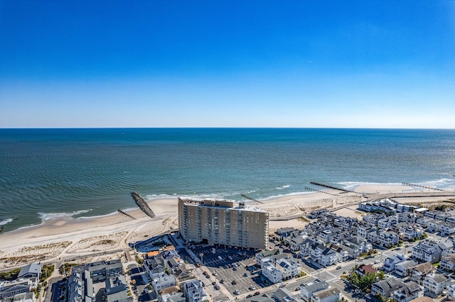 birds eye view of property featuring a water view and a beach view