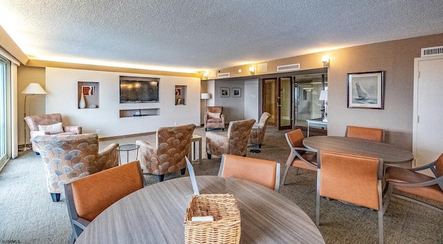 carpeted dining area with a textured ceiling