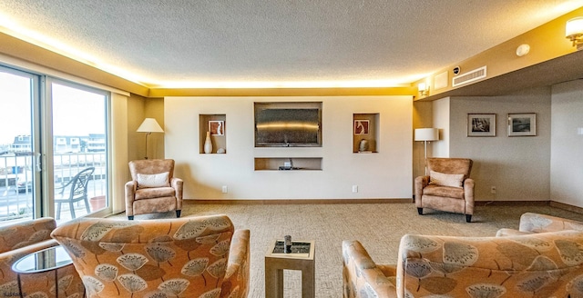 carpeted living room featuring a textured ceiling