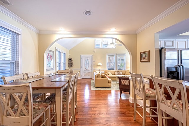 dining room featuring hardwood / wood-style flooring, ceiling fan, and crown molding