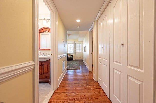 hall featuring dark wood-type flooring and sink