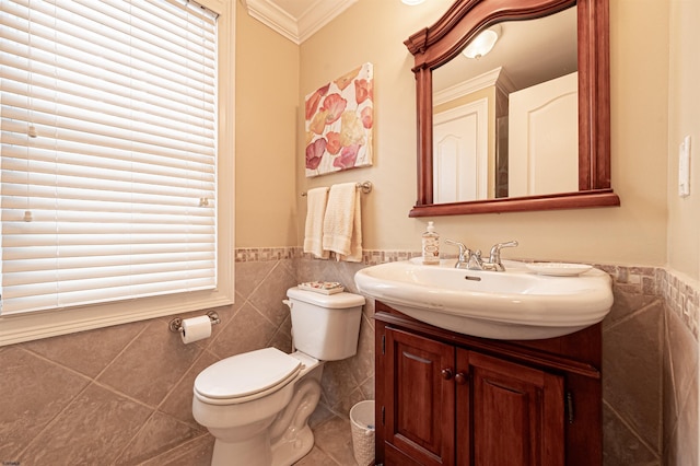 bathroom featuring vanity, tile patterned floors, crown molding, toilet, and tile walls