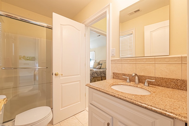 bathroom with toilet, tasteful backsplash, tile patterned floors, and walk in shower