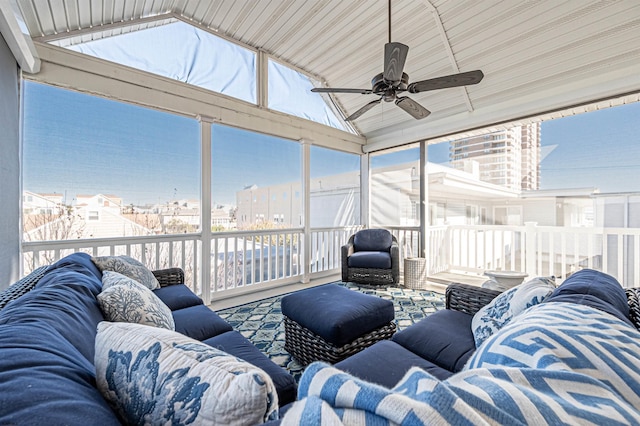 sunroom featuring ceiling fan and lofted ceiling