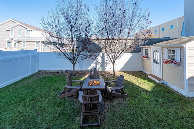 view of yard with an outdoor structure and a fire pit