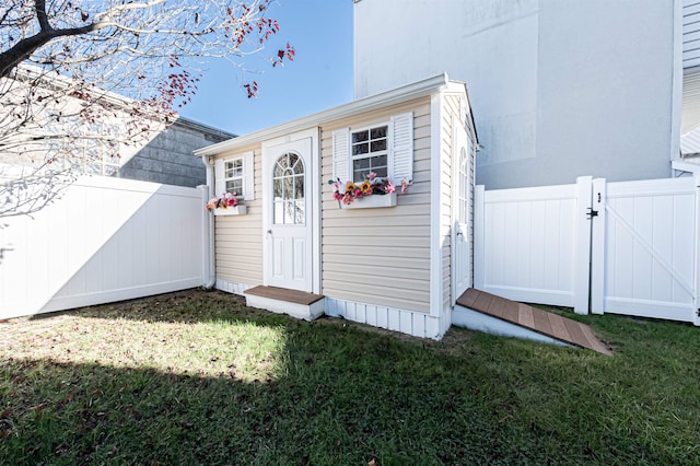 view of outbuilding featuring a lawn