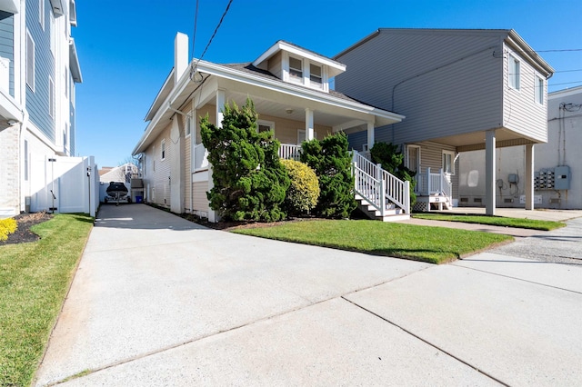 bungalow-style home with a porch and a front yard