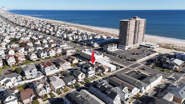 bird's eye view with a water view and a view of the beach