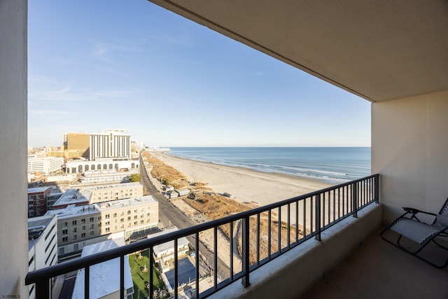 balcony with a water view and a beach view