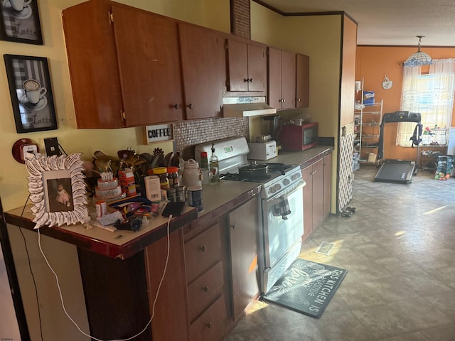 kitchen with pendant lighting, crown molding, and gas range gas stove