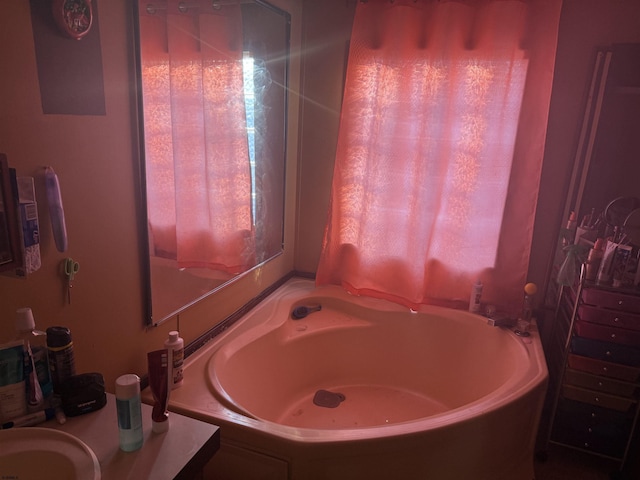 bathroom with a washtub and sink