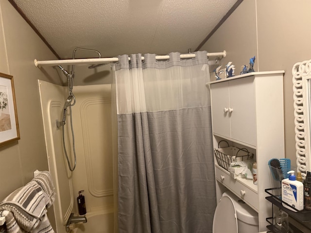 bathroom with shower / tub combo with curtain, a textured ceiling, and toilet