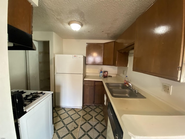 kitchen featuring a textured ceiling, white appliances, ventilation hood, and sink