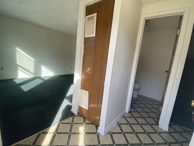 staircase with a textured ceiling