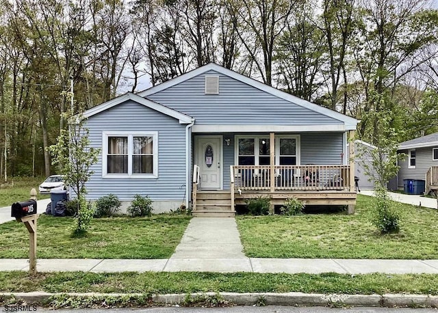 bungalow-style house featuring a front lawn and covered porch