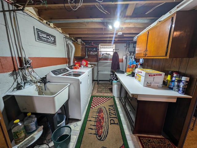 laundry area featuring cabinet space, washing machine and dryer, water heater, and a sink