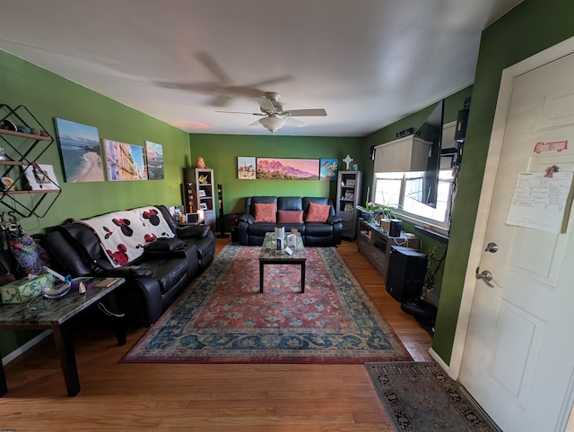 living room with ceiling fan and wood finished floors