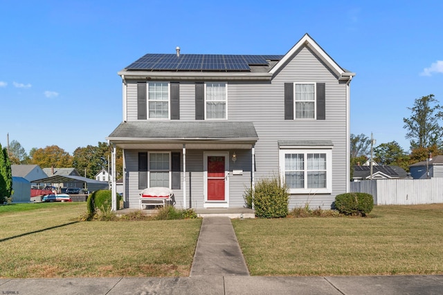 view of front facade featuring a front lawn and solar panels