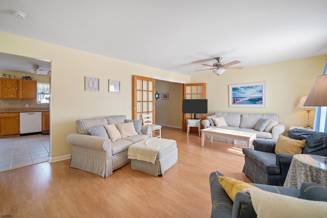 living room with ceiling fan and light wood-type flooring