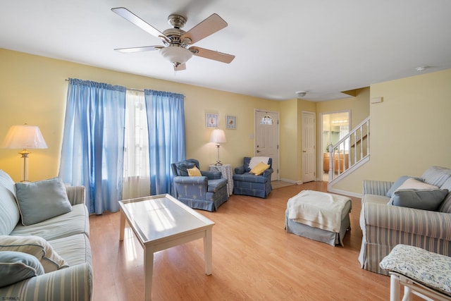 living room with ceiling fan and light hardwood / wood-style floors