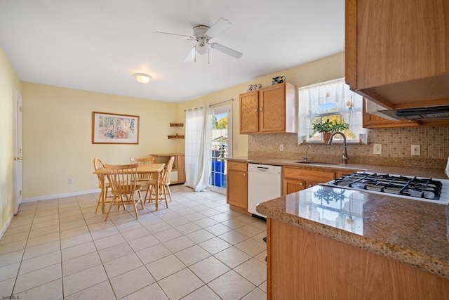 kitchen featuring tasteful backsplash, ceiling fan, sink, light tile patterned floors, and dishwasher