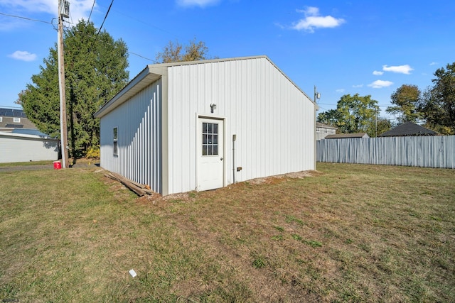 view of outbuilding with a yard