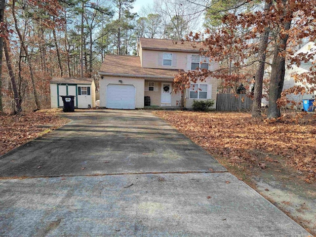 view of front of home featuring a storage unit and a garage