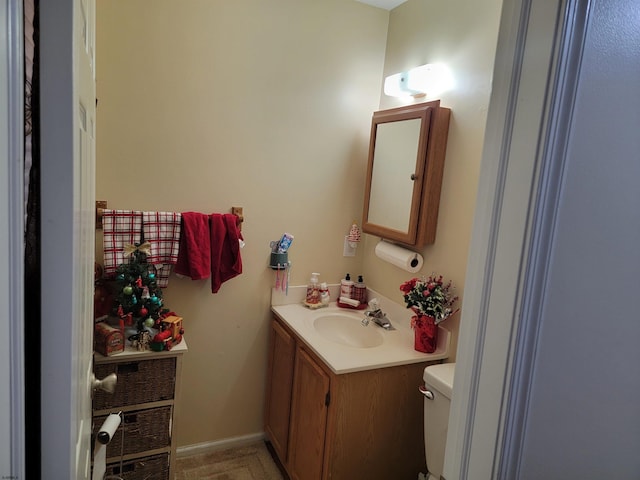 half bathroom with toilet and vanity