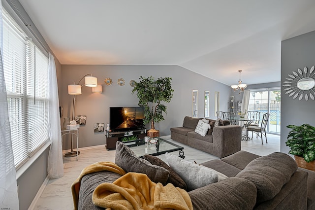 living room featuring lofted ceiling and a chandelier