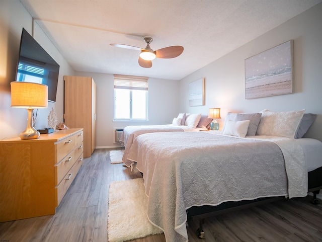 bedroom featuring ceiling fan and hardwood / wood-style flooring