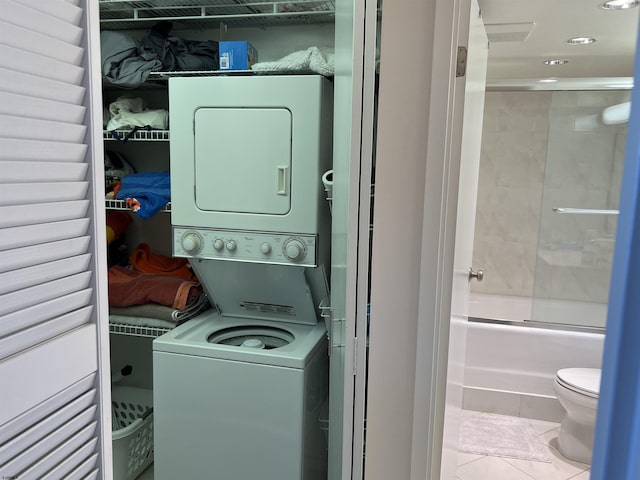 washroom featuring tile patterned floors and stacked washer and clothes dryer