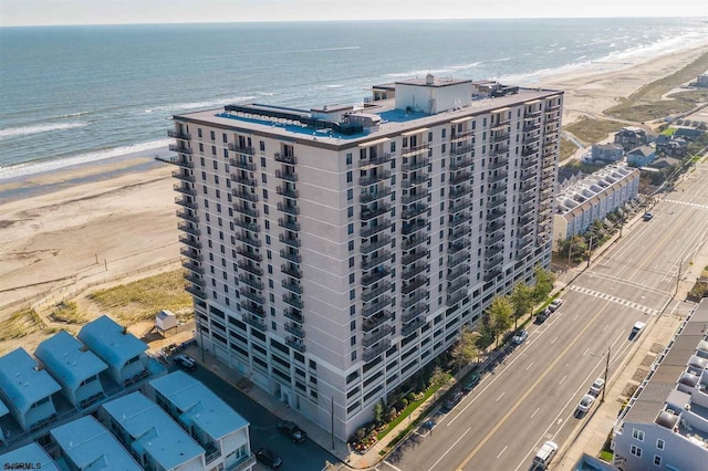 aerial view with a water view and a beach view