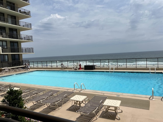 view of pool with a water view