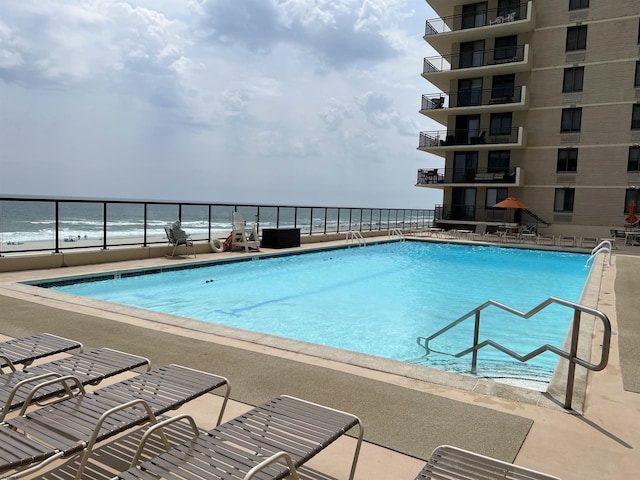 view of pool with a water view