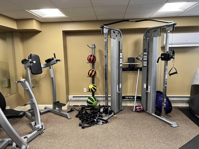 exercise room with a paneled ceiling