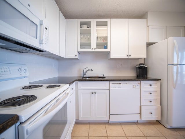 kitchen featuring white cabinetry and white appliances