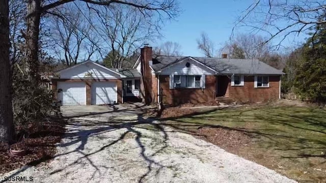 ranch-style house with a front yard and a garage