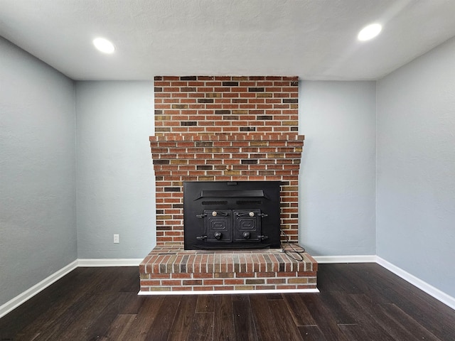 room details with wood-type flooring and a wood stove