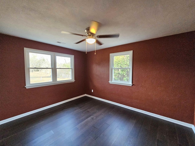 empty room featuring ceiling fan and dark hardwood / wood-style flooring