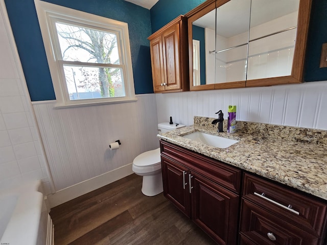 full bathroom with vanity, hardwood / wood-style floors, shower / washtub combination, and toilet