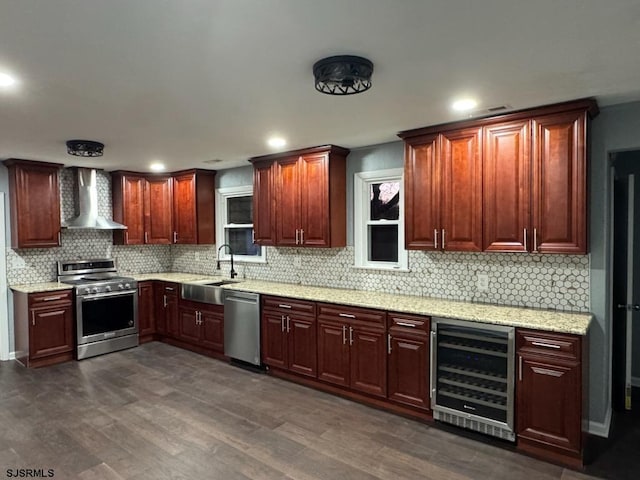 kitchen with sink, beverage cooler, dark hardwood / wood-style flooring, stainless steel appliances, and wall chimney range hood