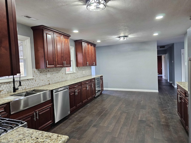 kitchen featuring sink, dark hardwood / wood-style floors, wine cooler, light stone countertops, and stainless steel dishwasher