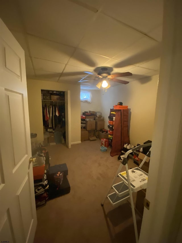 interior space with a paneled ceiling and a closet