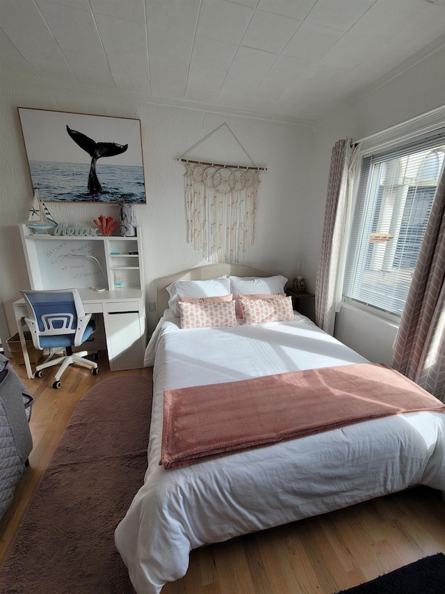 bedroom with hardwood / wood-style floors